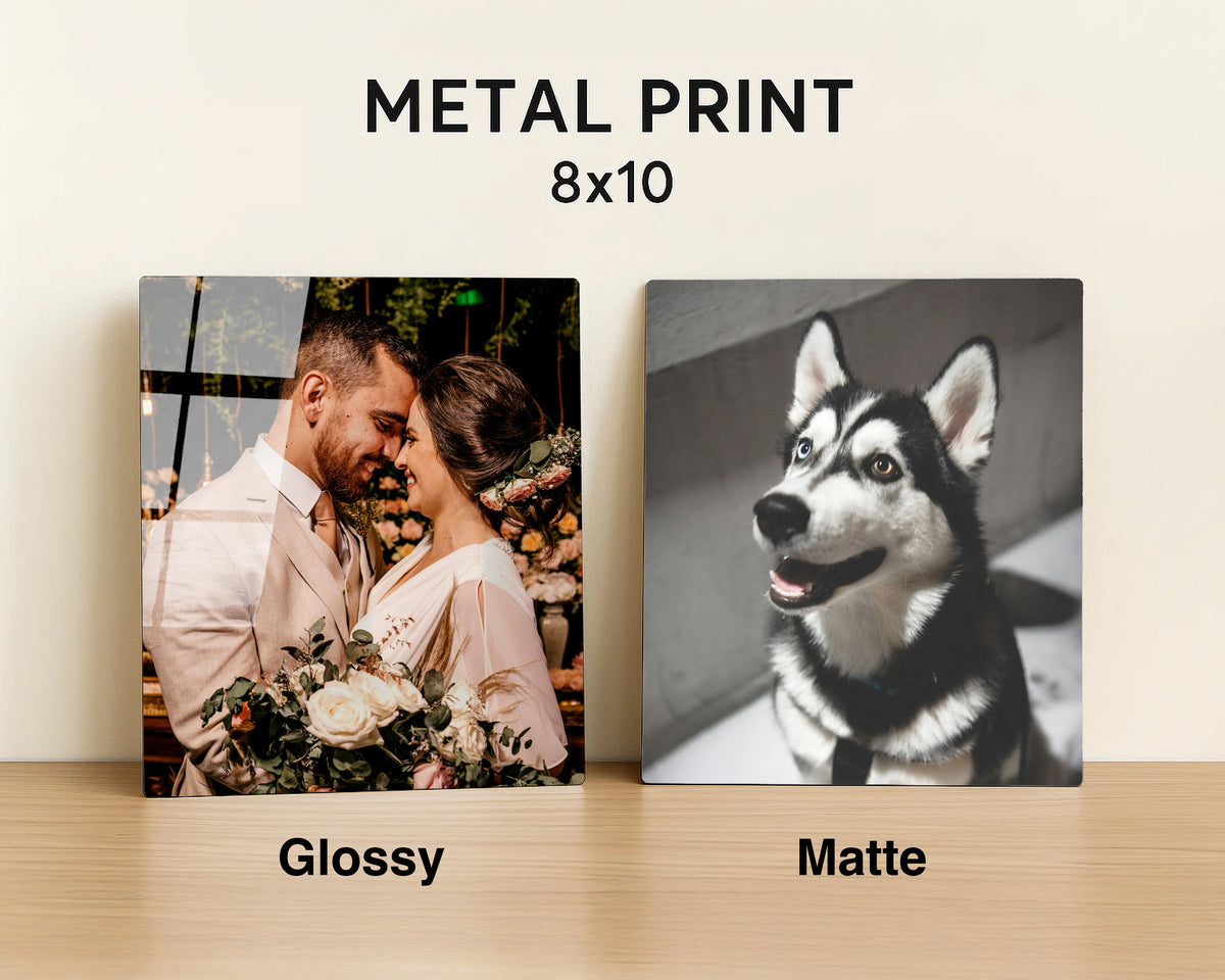 Two square metal photo prints displayed side by side on a light wood surface against a cream wall. Text at the top reads 'METAL PRINT 8x10', with 'Glossy' under the left print and 'Matte' under the right print.