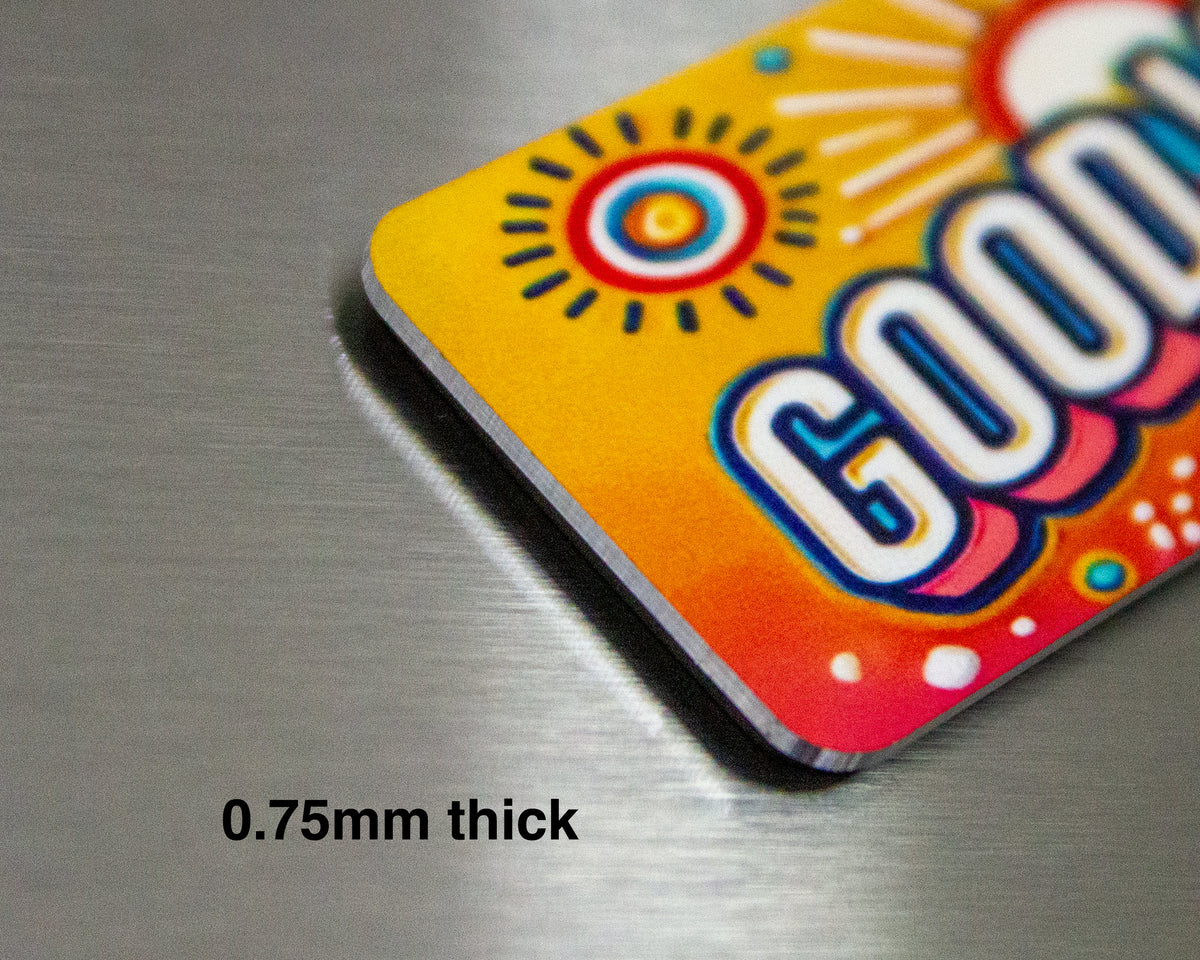 Colorful personalized fridge magnet showing thickness of 0.75mm  with the text good vibes.
