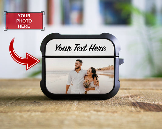 A customizable black AirPods Pro 1st 2nd or 3rd Gen case mockup standing on a wooden surface, showing a sample photo of a couple and placeholder text 'Your Text Here'. A red arrow points to the case, and a red label in the top left says 'YOUR PHOTO HERE'.