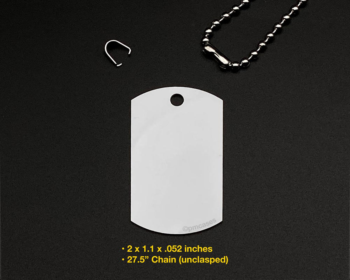 A silver metal dog tag pendant necklace on a black textured background, with a small silver clasp and part of the ball chain visible. Yellow text at the bottom reads: '2 x 1.