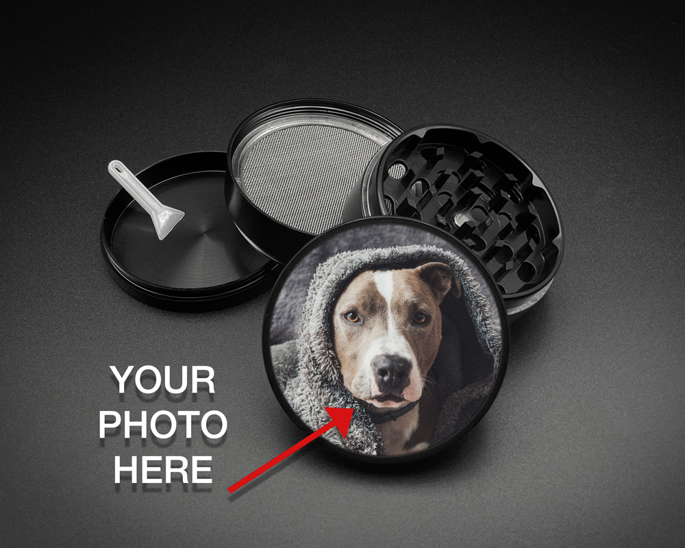 Personalized black four-piece herb grinder with a custom dog photo on the glossy lid, magnetic grinding chamber, mesh screen, collection chamber and scraper.